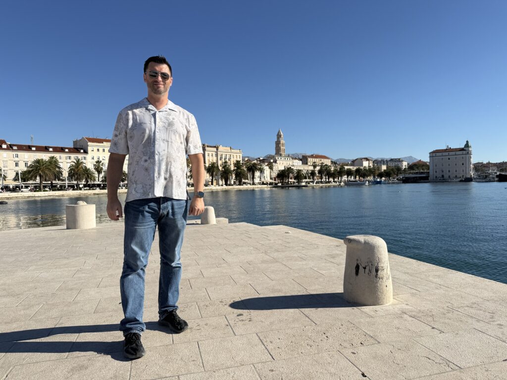 Solo traveller standing on a pier in Split harbour.